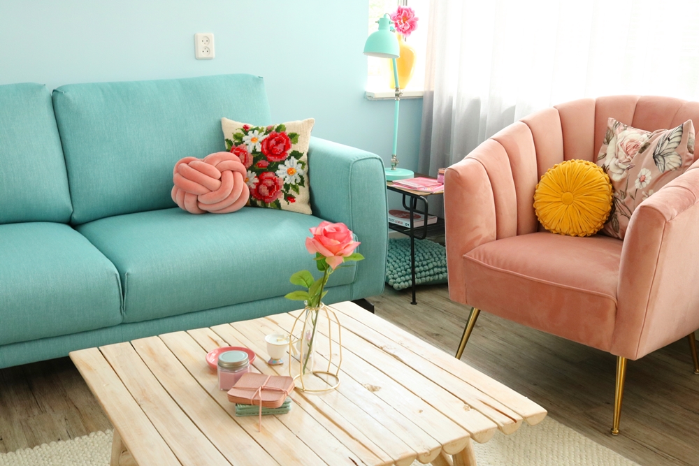 kleurrijke woonkamer blauwe bank roze stoel